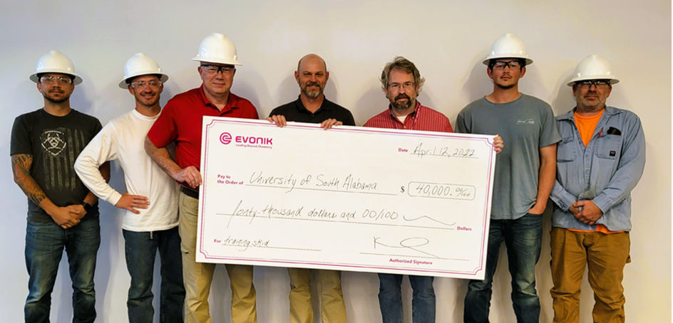Evonik donated $40,000 for the PTEC program at the University of South Alabama. Pictured are PTEC students and representatives of Evonik and the school. Holding the check (left to right): Steve Duff (University of South Alabama), Chris Mitchell, and Kel Boisvert (both Evonik).