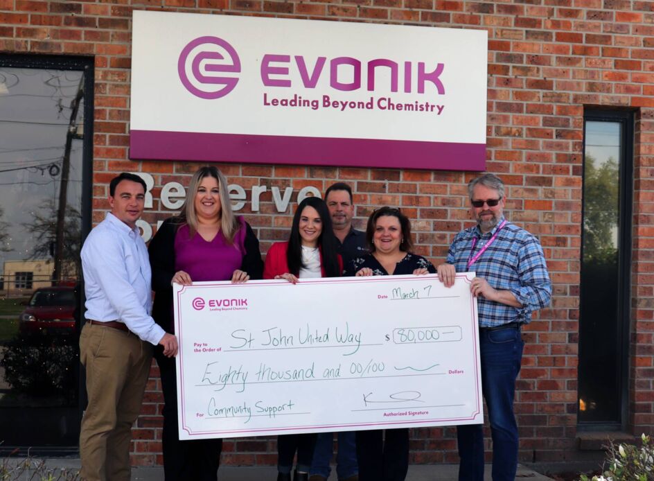 Evonik representatives present a $80,000 check to St. John United Way in front of Evonik’s site in Reserve, Louisiana.